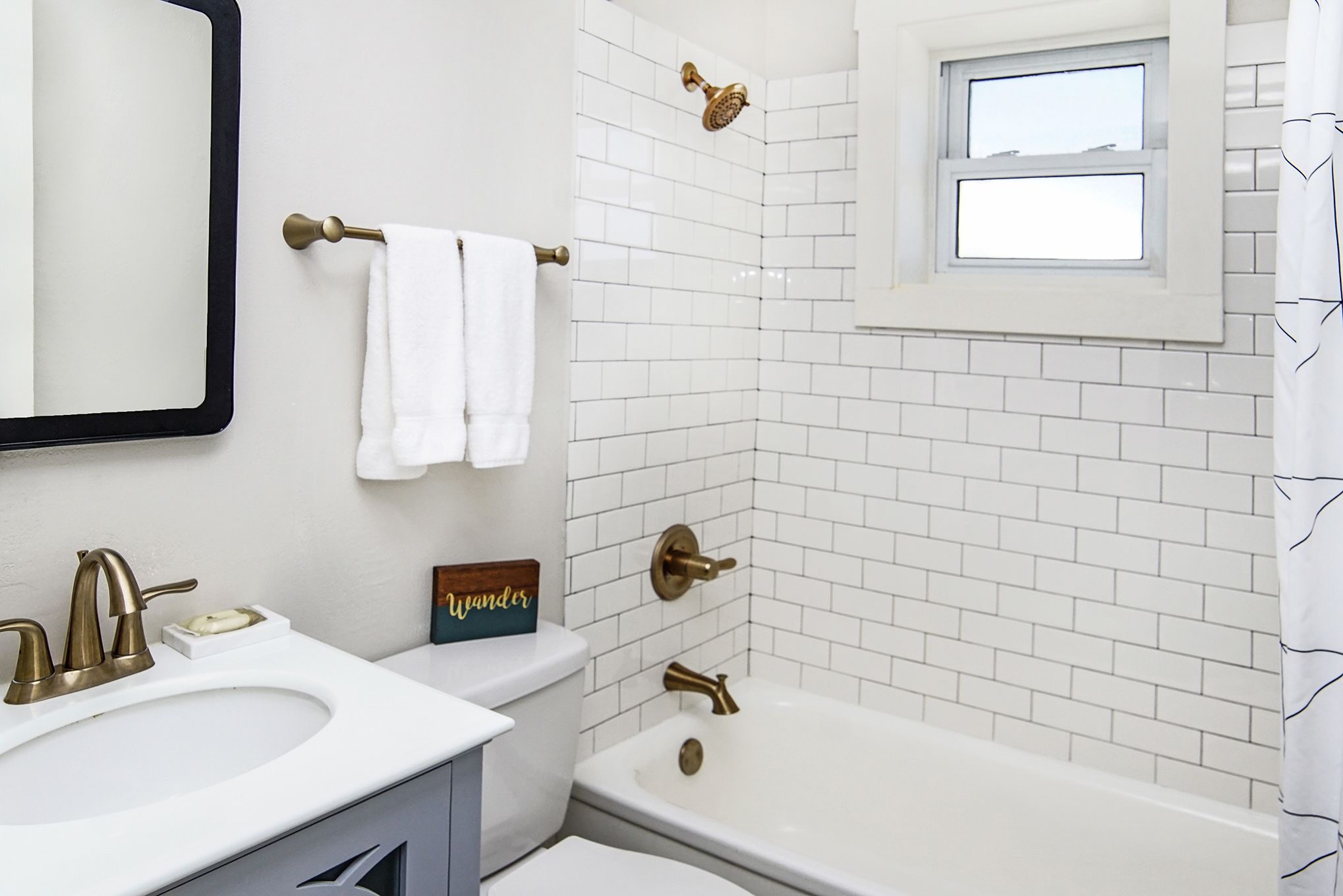 A bathroom with a white sink, a toilet, a bathtub, and a shower.