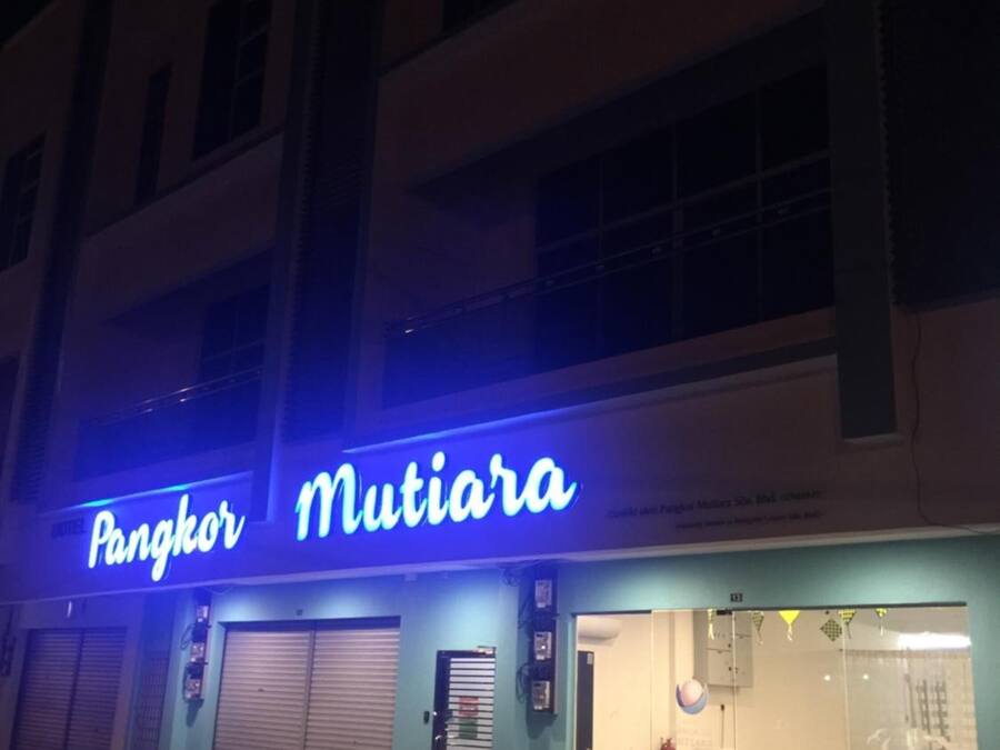 A building with a neon sign reading "Pangkor Mutiaru".