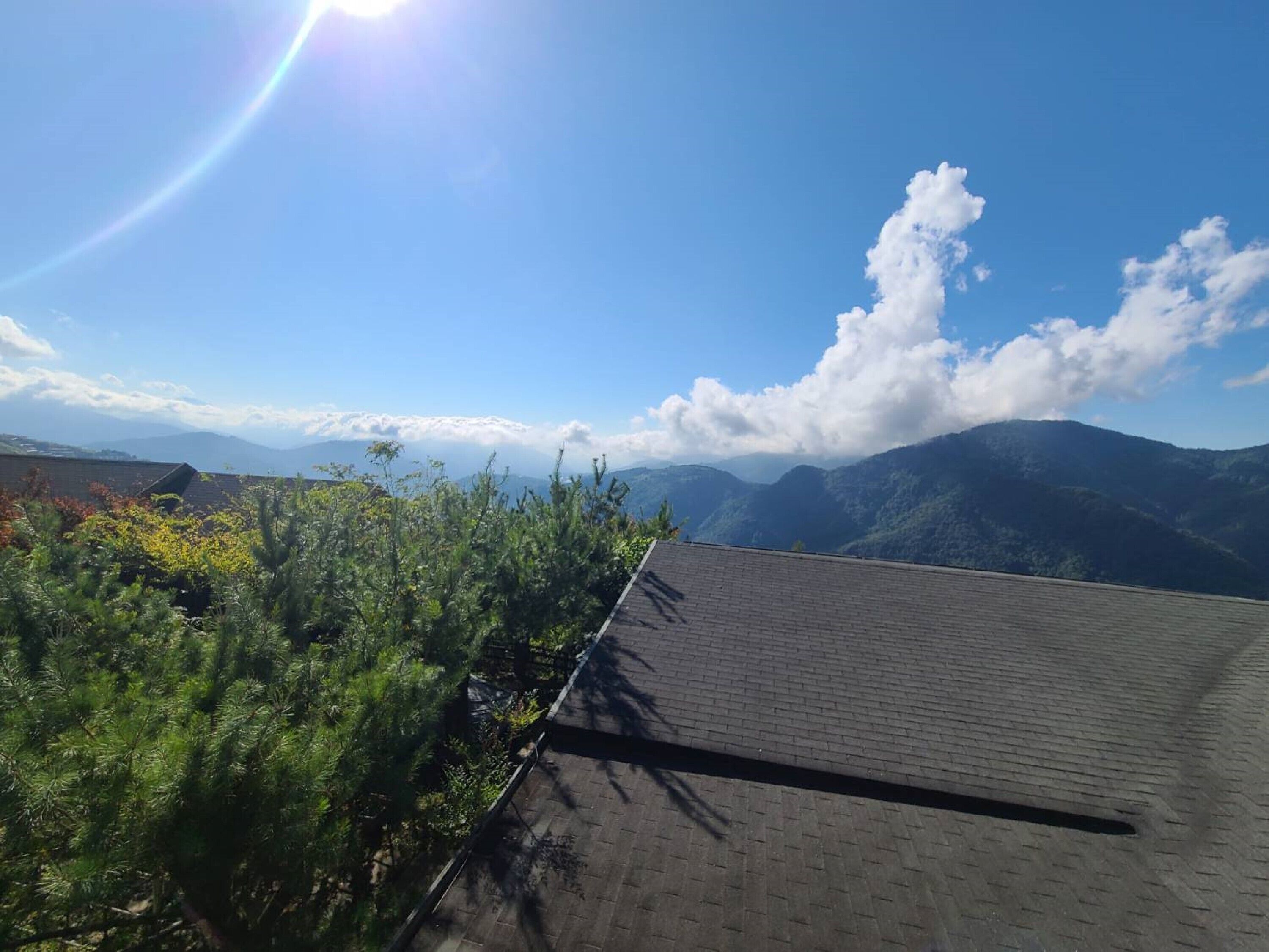 A rooftop with a view of mountains and a clear sky.