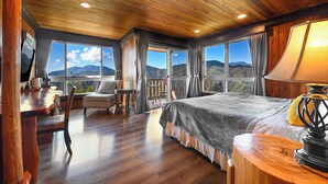 A wooden-paneled bedroom with a bed, a desk, and a chair. - Top Cloud Villa (Ren'ai)