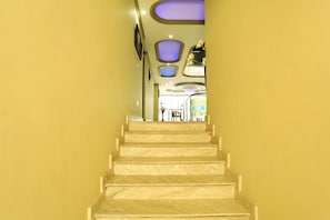 Escadaria que leva a um quarto com vista para uma área de jantar.