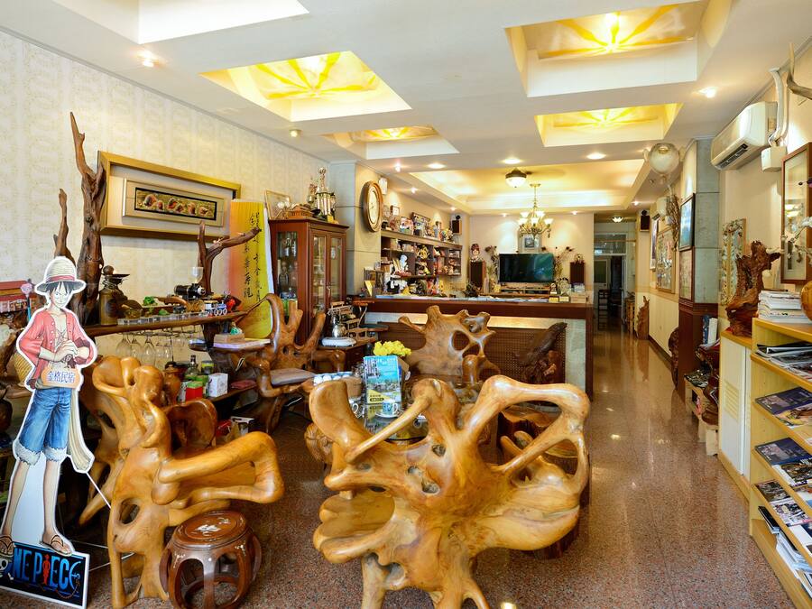A spacious living room with a wooden coffee table, a television, and various decorative items.