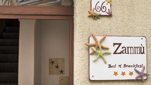 A sign with the number 66 and the name 'Zammu' indicating a room or establishment. - zammu bed and breakfast (Castellammare del Golfo)
