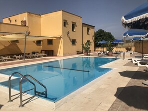 Seasonal outdoor pool, an infinity pool, pool loungers