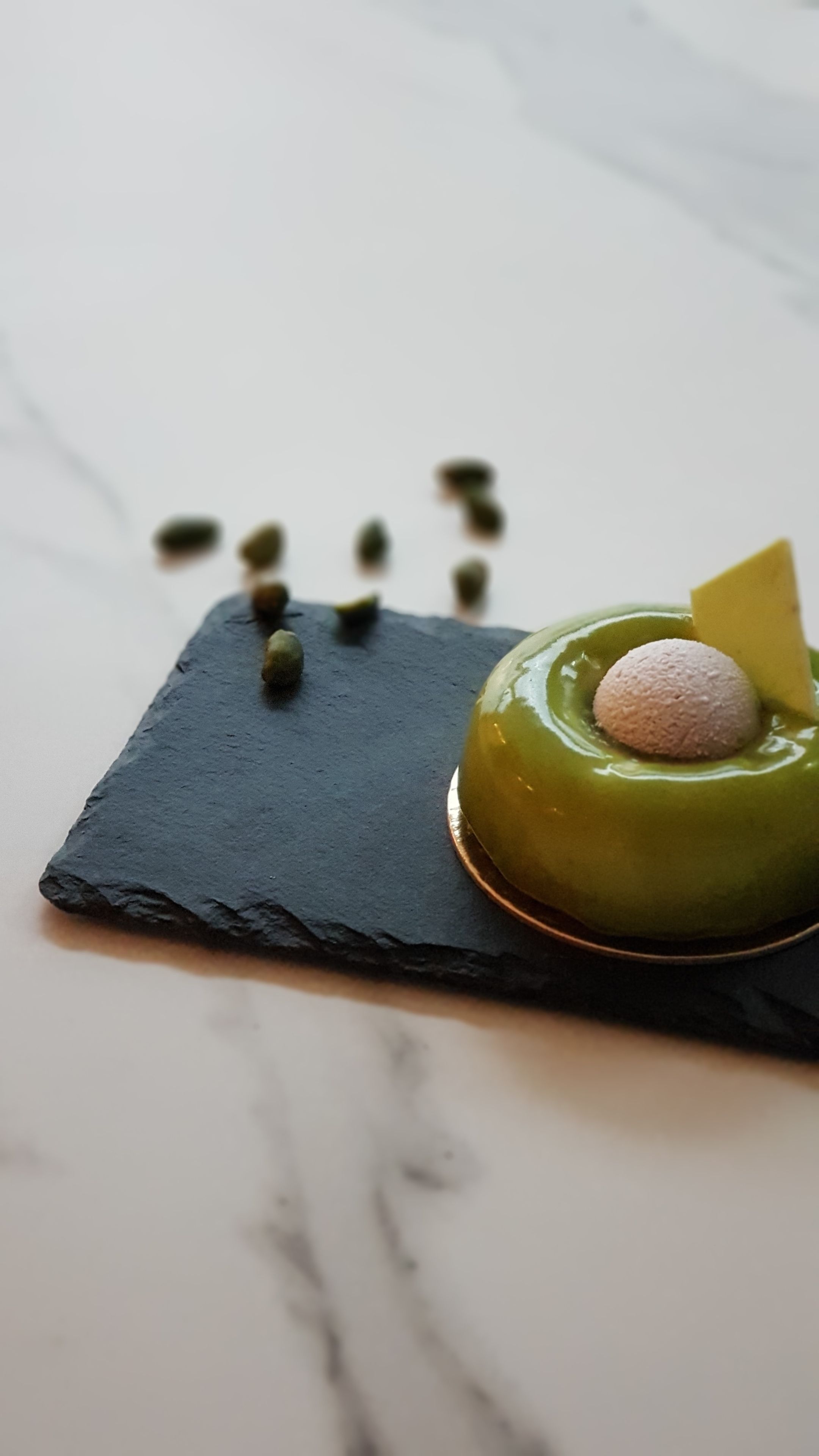 A dessert on a slate plate with a marble background.