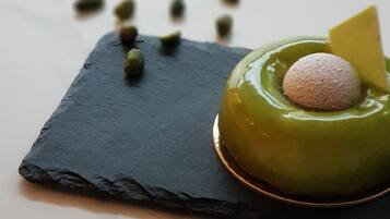 A dessert on a slate plate with a marble background.