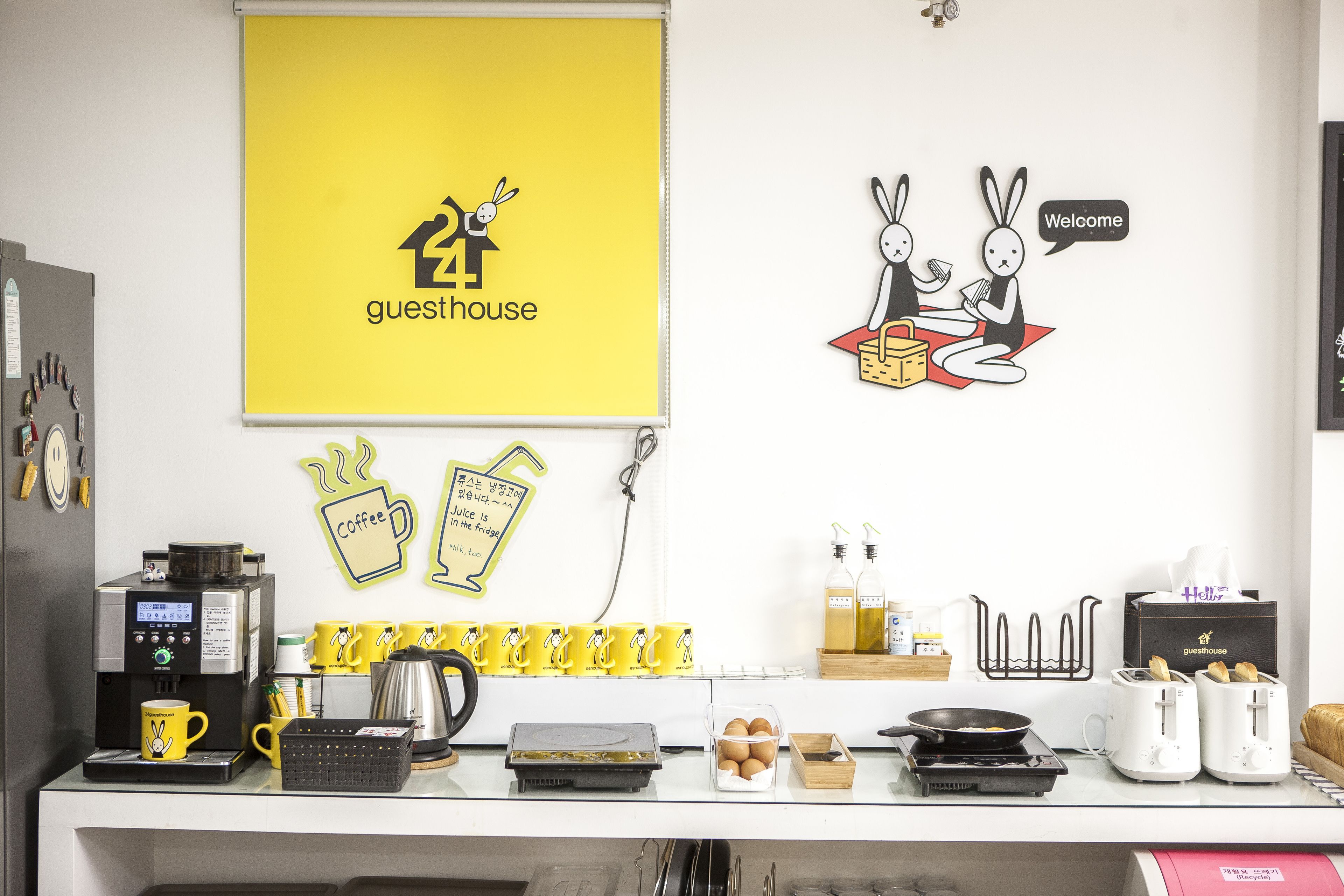 A kitchen area with a coffee machine, toaster, and various kitchen utensils.