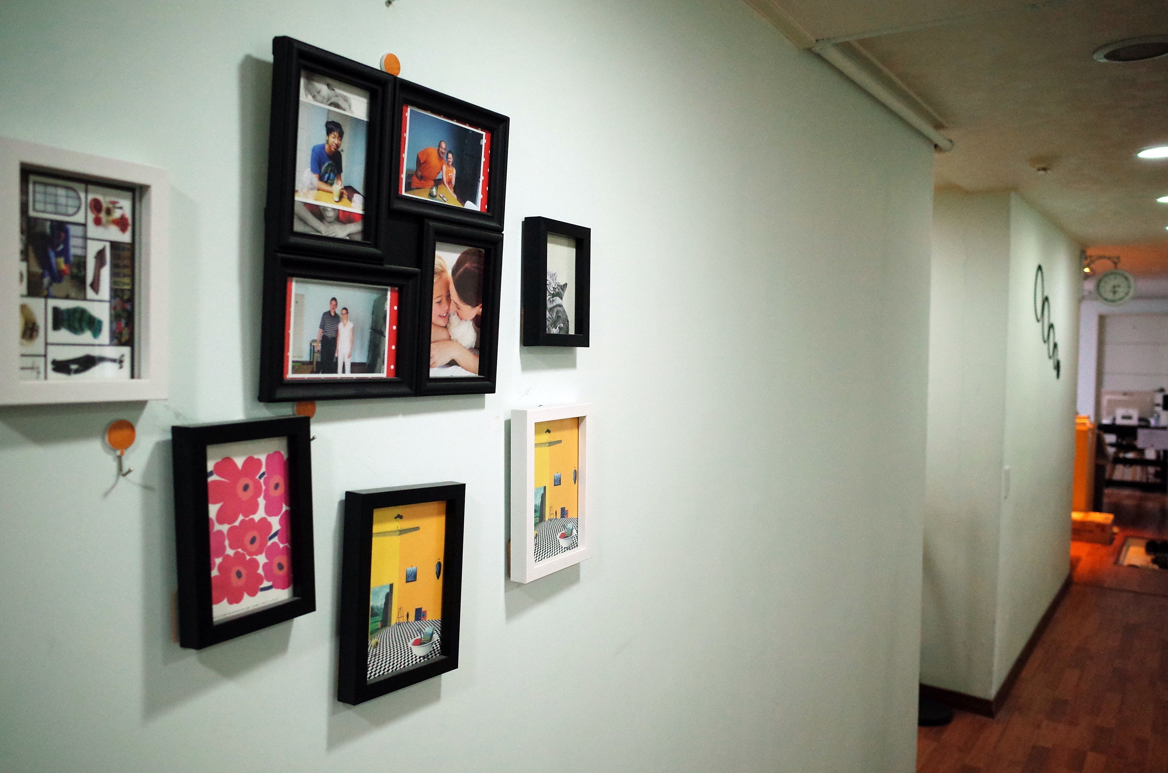A hallway with framed artwork on the walls.