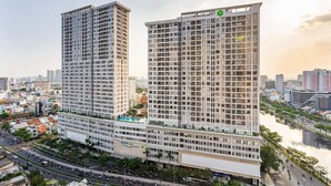 Two high-rise buildings with a river in the background. - River Gate Apartment Saigon HCMC (Ho Chi Minh City)