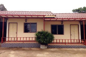 A two-story building with a red-tiled roof, a brick foundation, and a small front porch with a railing. - Zigzag Resort Mukdahan (Mukdahan)
