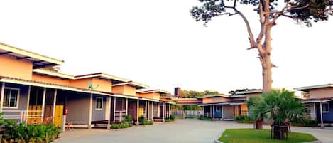 A row of modern, single-story buildings with a central courtyard.