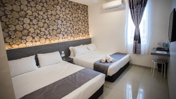 A hotel room with two beds, a ceiling fan, a wall-mounted air conditioner, and a window with curtains. - IM 96 Villa (Kuantan)