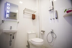 Bathroom features a sink, toilet, shower, and towel rack.