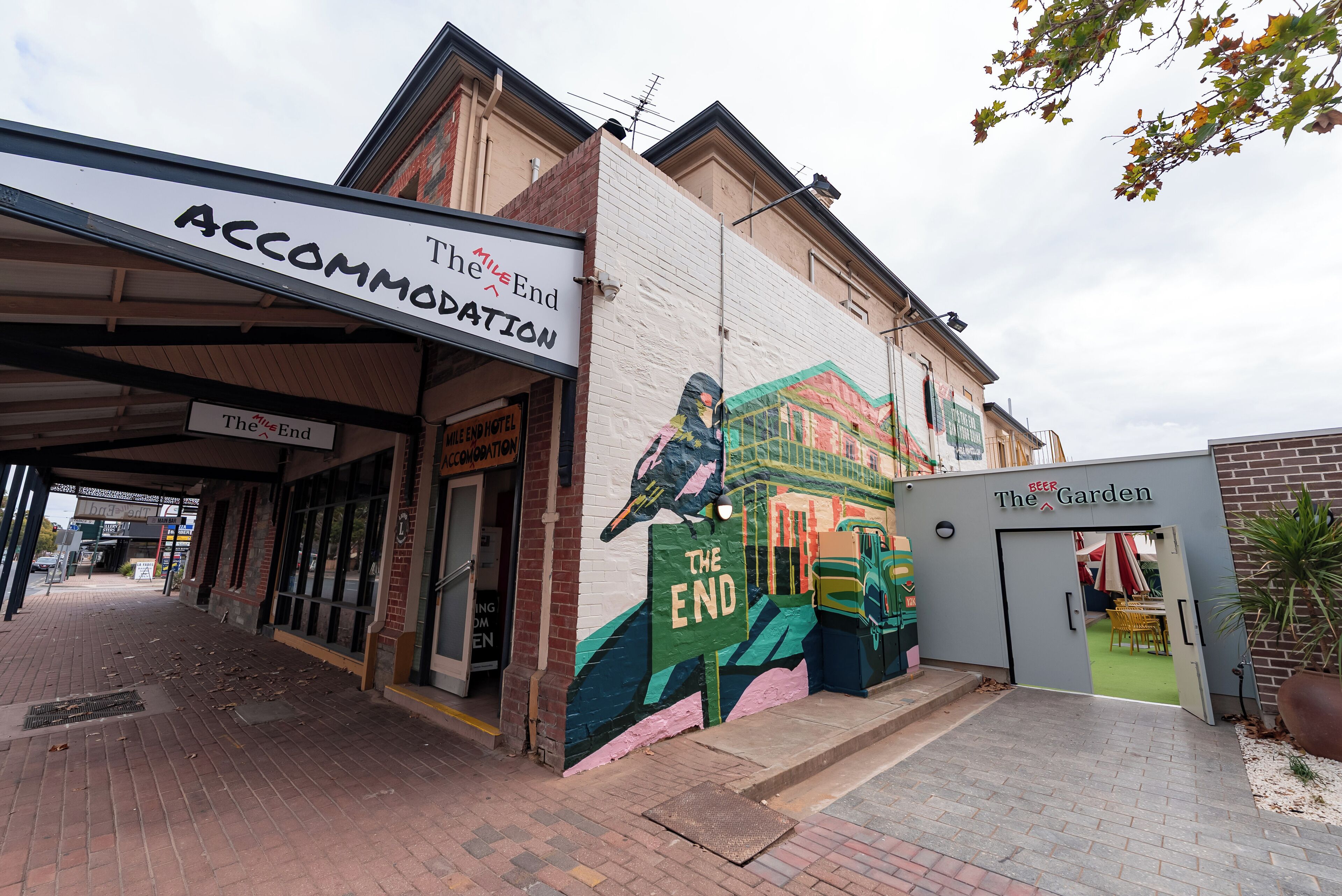 A building with a mural of a bird and the words 'The End' on the side.