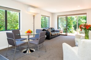 Premium Cottage, 1 Bedroom, Non Smoking, Kitchen (Rose) | Living room | 40-inch flat-screen TV with digital channels, Smart TV, Netflix - Lawn Cottages (Clive)