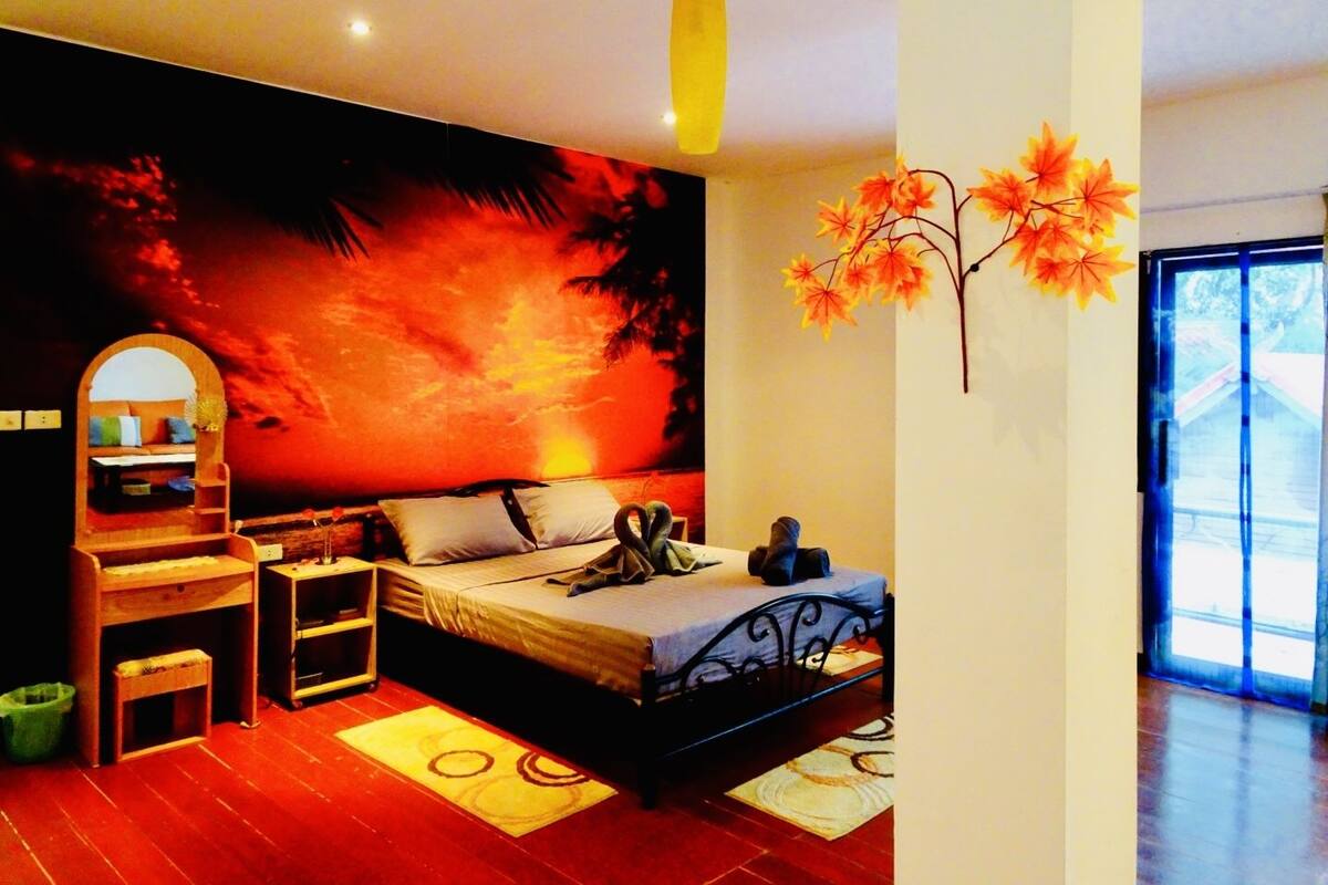 A modern bedroom with a large bed, a nightstand, a dresser, and a mirror.