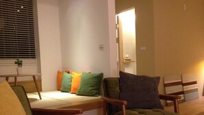 A living room with a sofa set, two armchairs, and a small table. - Missy House (Wujie)