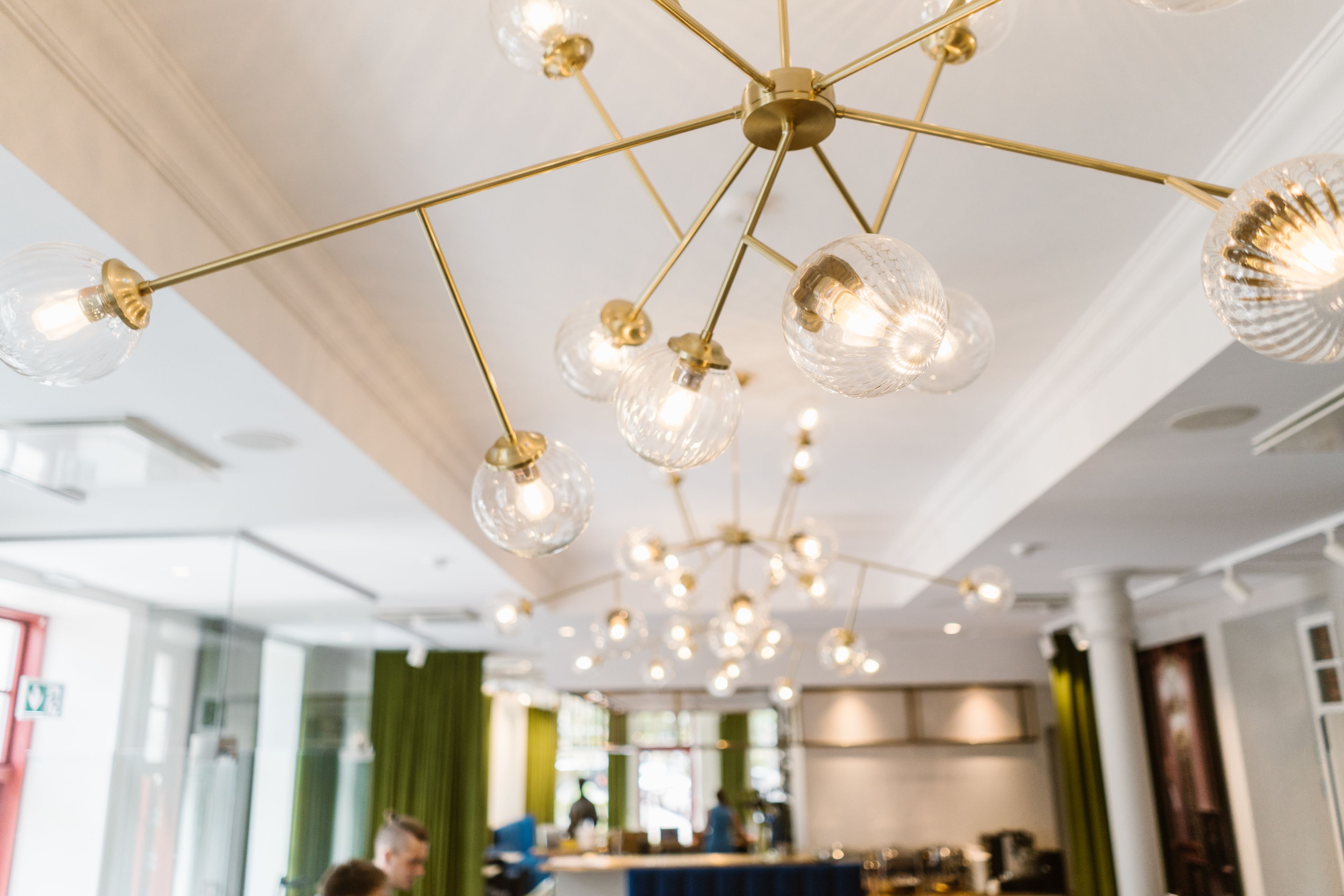 A modern interior with a ceiling adorned with multiple hanging light fixtures.