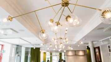 A modern interior with a ceiling adorned with multiple hanging light fixtures.
