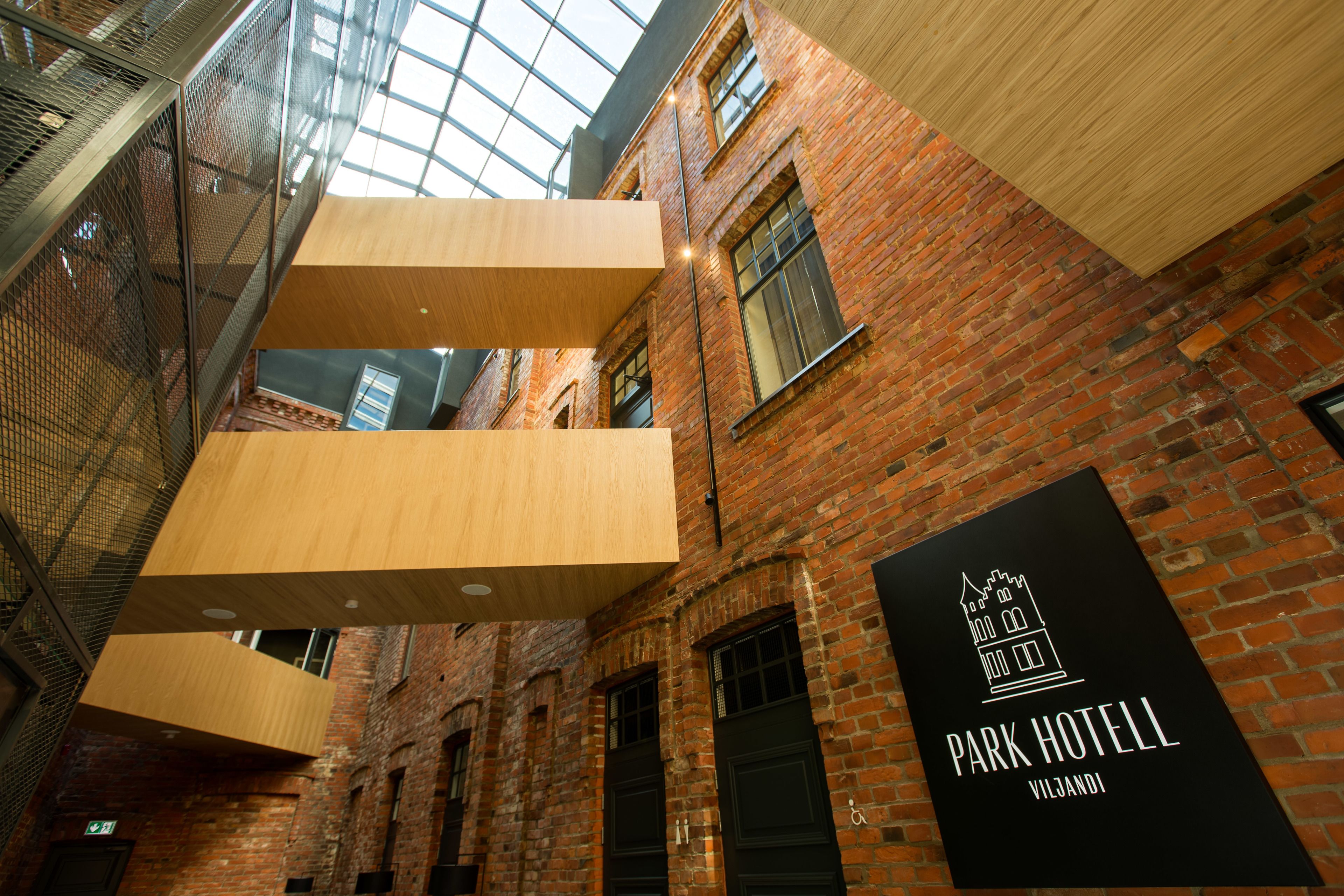 A brick building with a sign for Park Hotel Viljandi.
