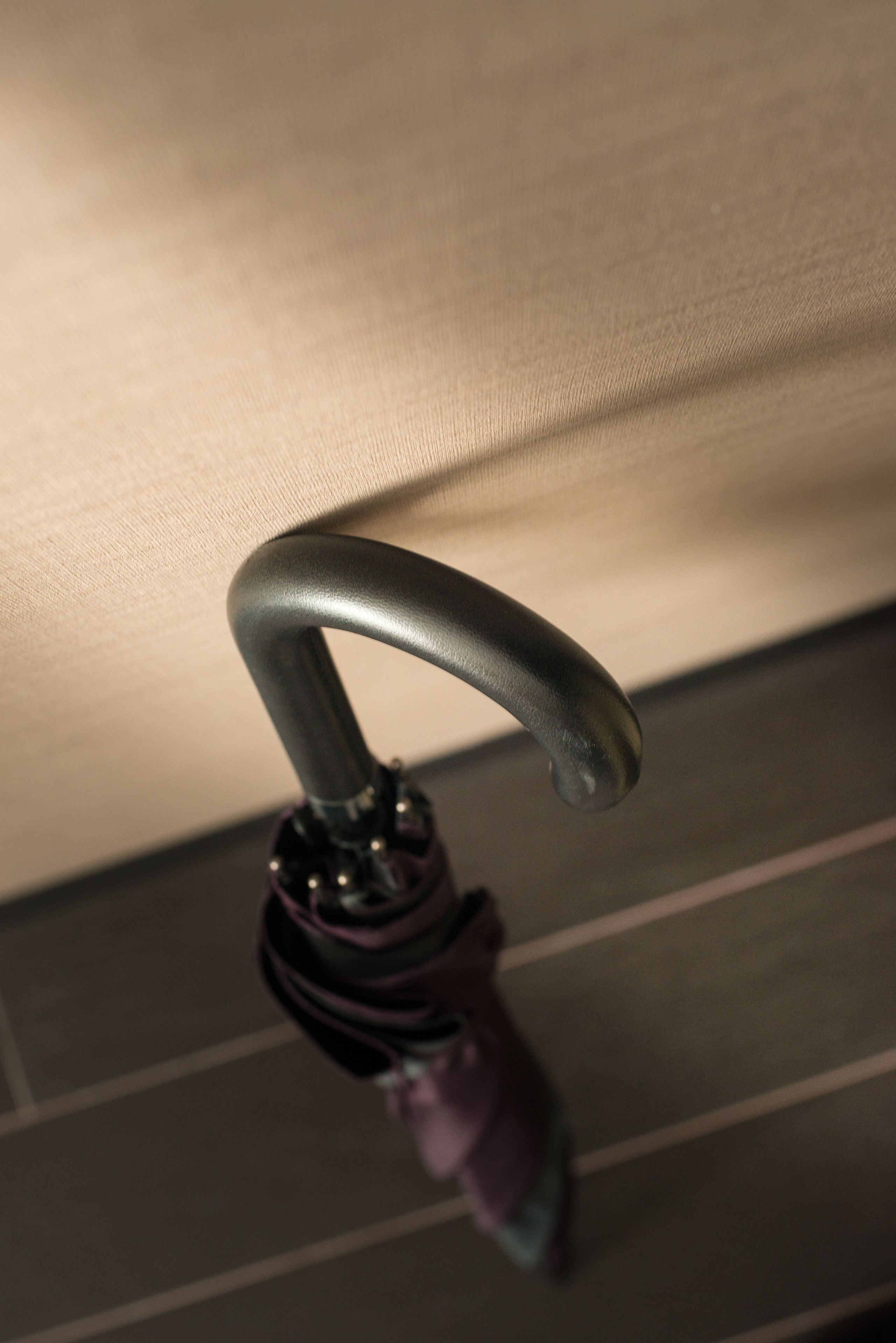 A close-up of a metallic handle, likely part of a piece of furniture or equipment.