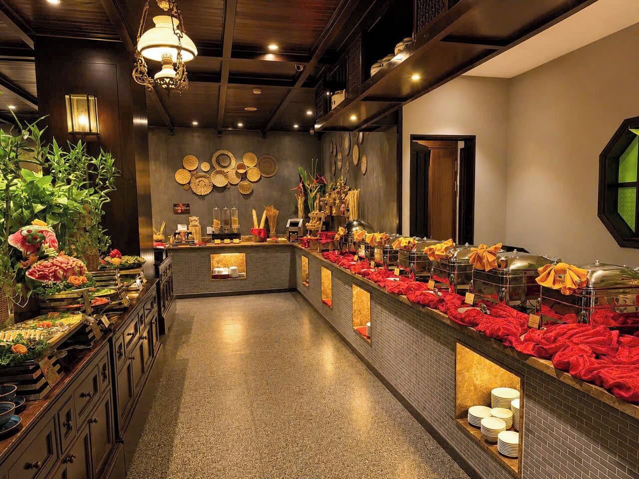 A buffet area with a variety of food items and a long counter.