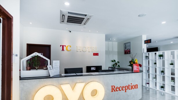 A hotel reception area with a modern design, featuring a reception desk labeled "TC HOTEL" and "Reception". - Super OYO 326 Tc Hotel (Petaling Jaya)