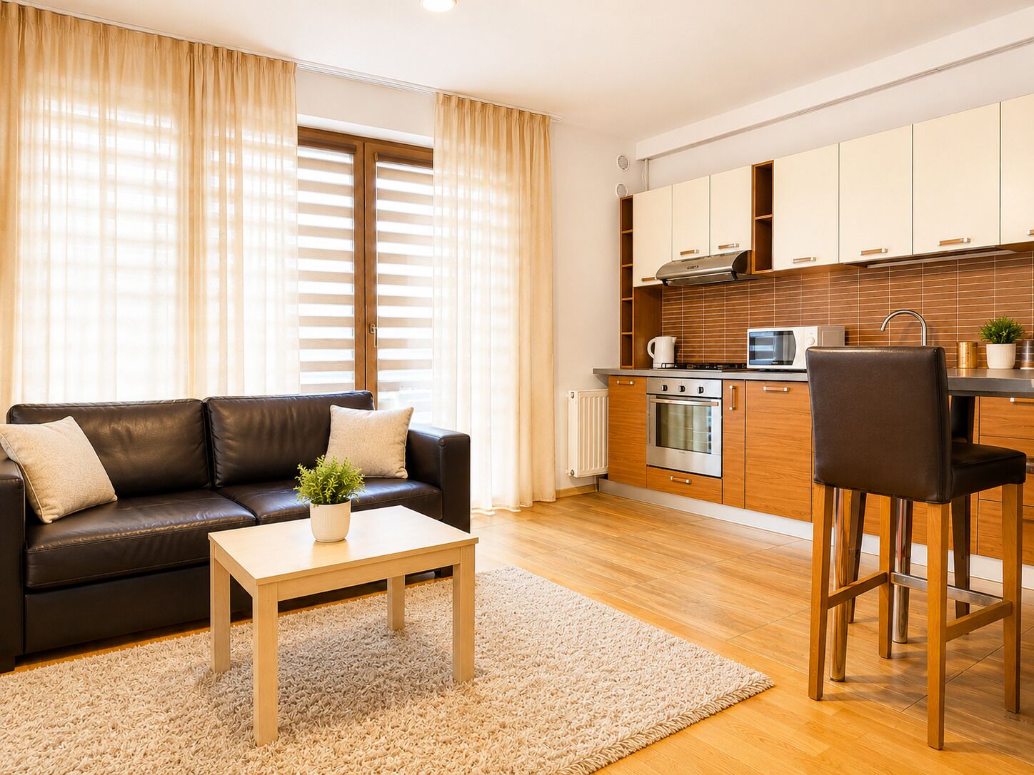 A modern living room with a sofa, coffee table, and a small potted plant.