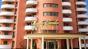 A multi-story hotel with a prominent entrance and a sign reading 'Monte Carlo Palace.' - Monte Carlo Palace Rooms  (Bucharest)