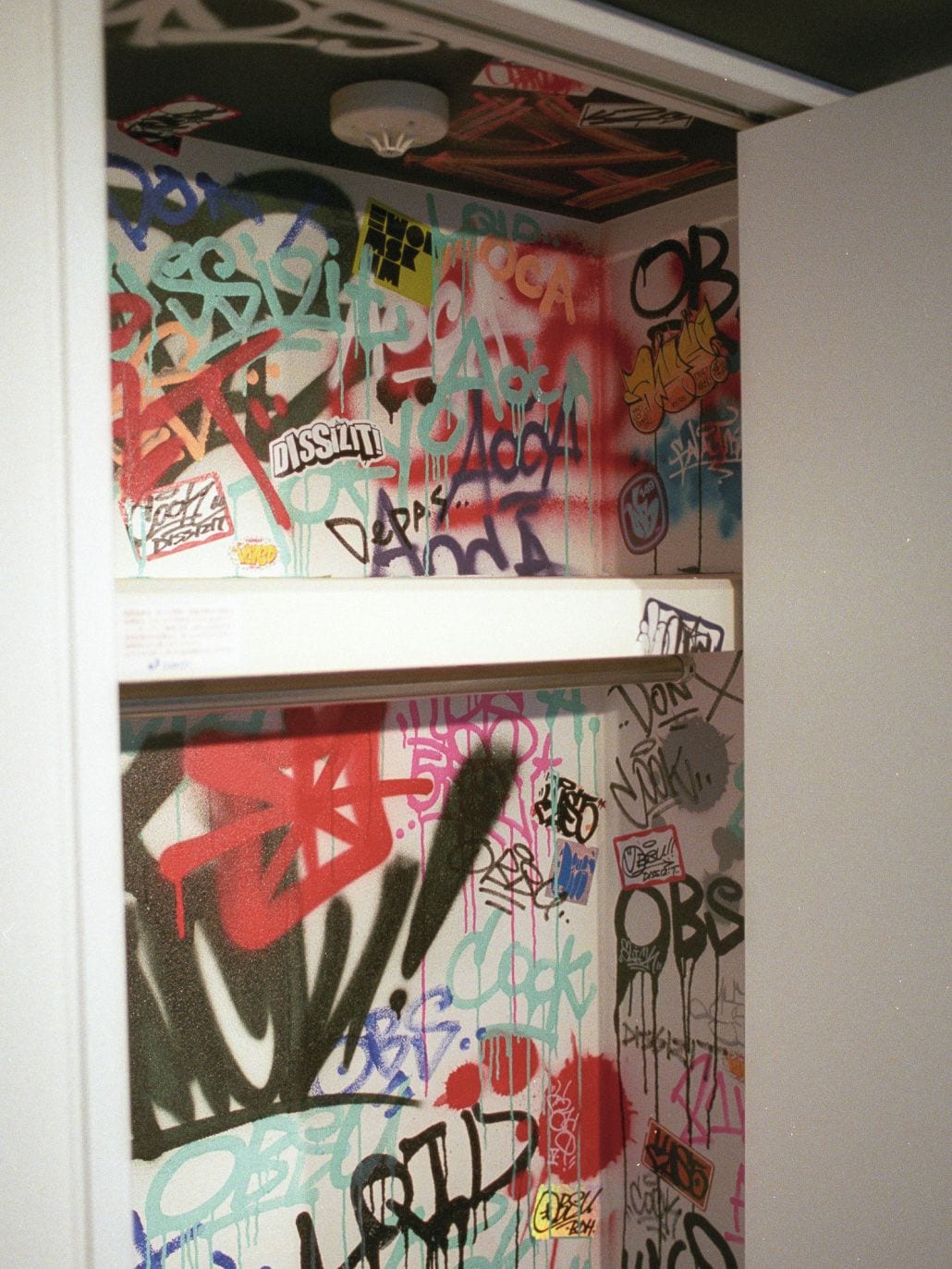 A room with graffiti on the walls and ceiling.