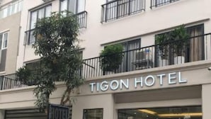 A hotel named Tigon Hotel with a modern facade, large windows, and a signboard. - Tigon Hotel (Hanoi)