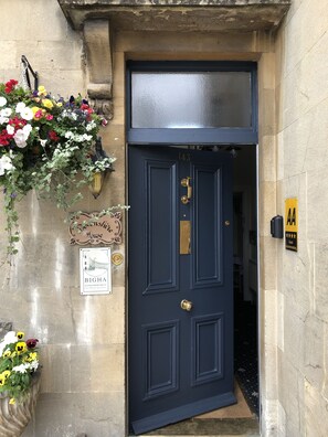 A dark blue door with the number 143, a sign indicating 'BIGHAM' and 'GUEST ACCOMMODATION', and a yellow sign with 'AA' and three stars. - Devonshire House (Bath)