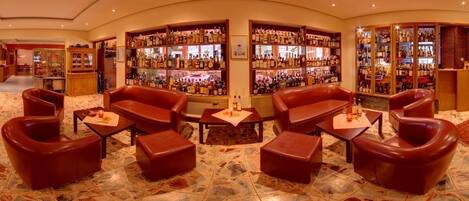 A bar area with leather seating and a large liquor display.