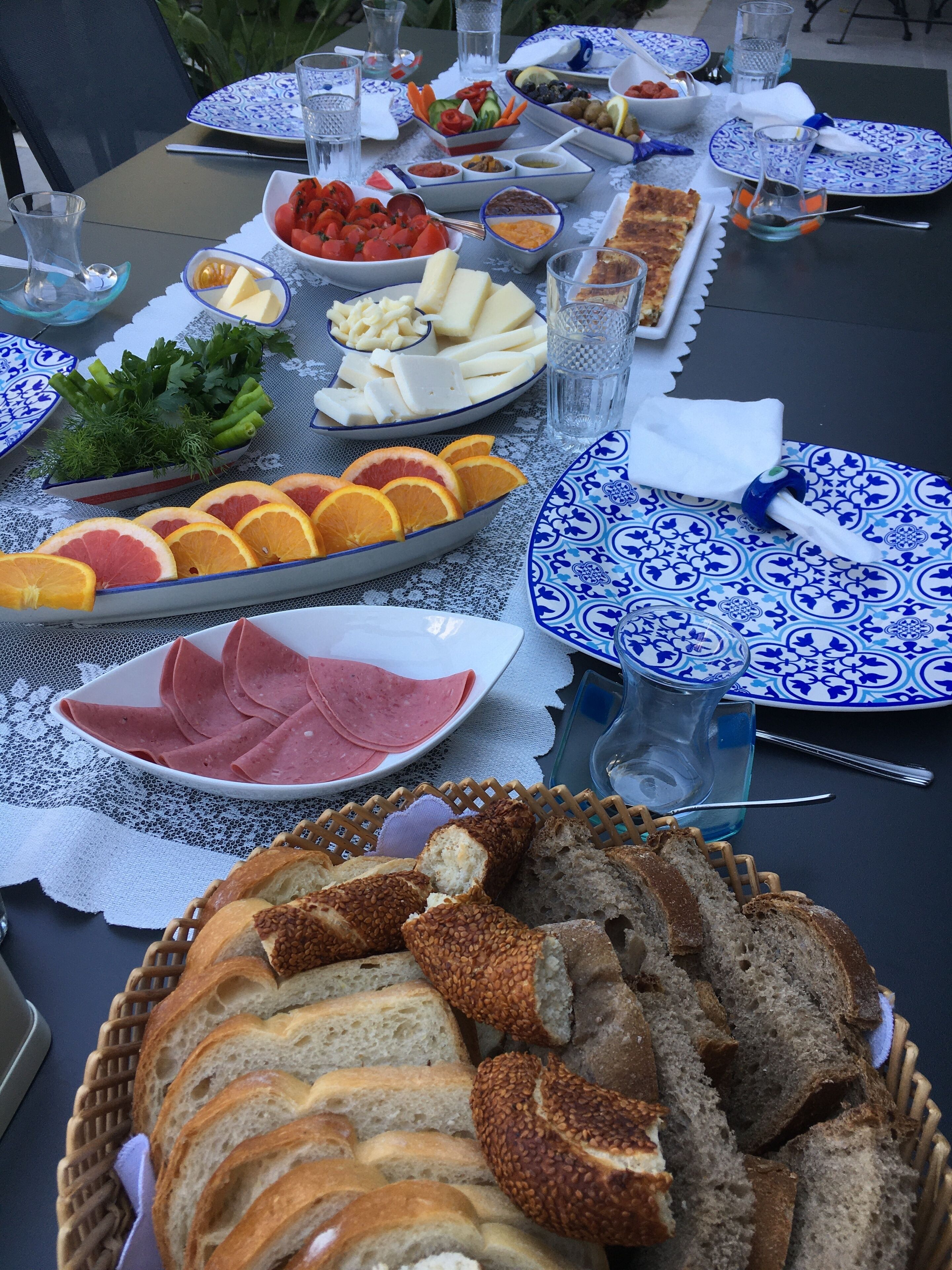 A table set with various food items including bread, cheese, and fruits.