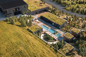 A modern building with a rooftop garden, a swimming pool, and a landscaped outdoor area. - 360 Hotel Boutique and Spa (Selfoss)