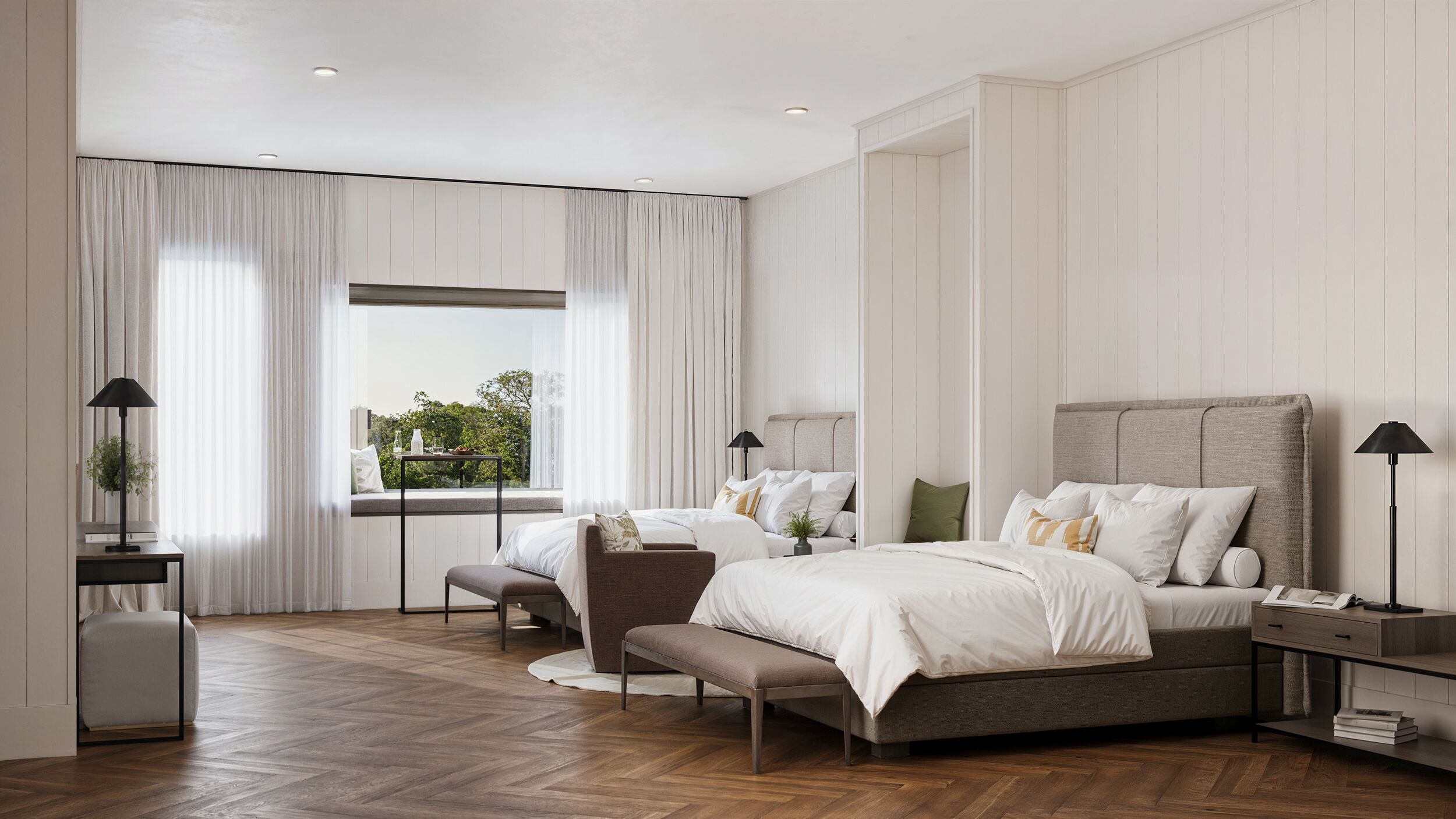 A modern bedroom with two beds, a large window, and a view of greenery.