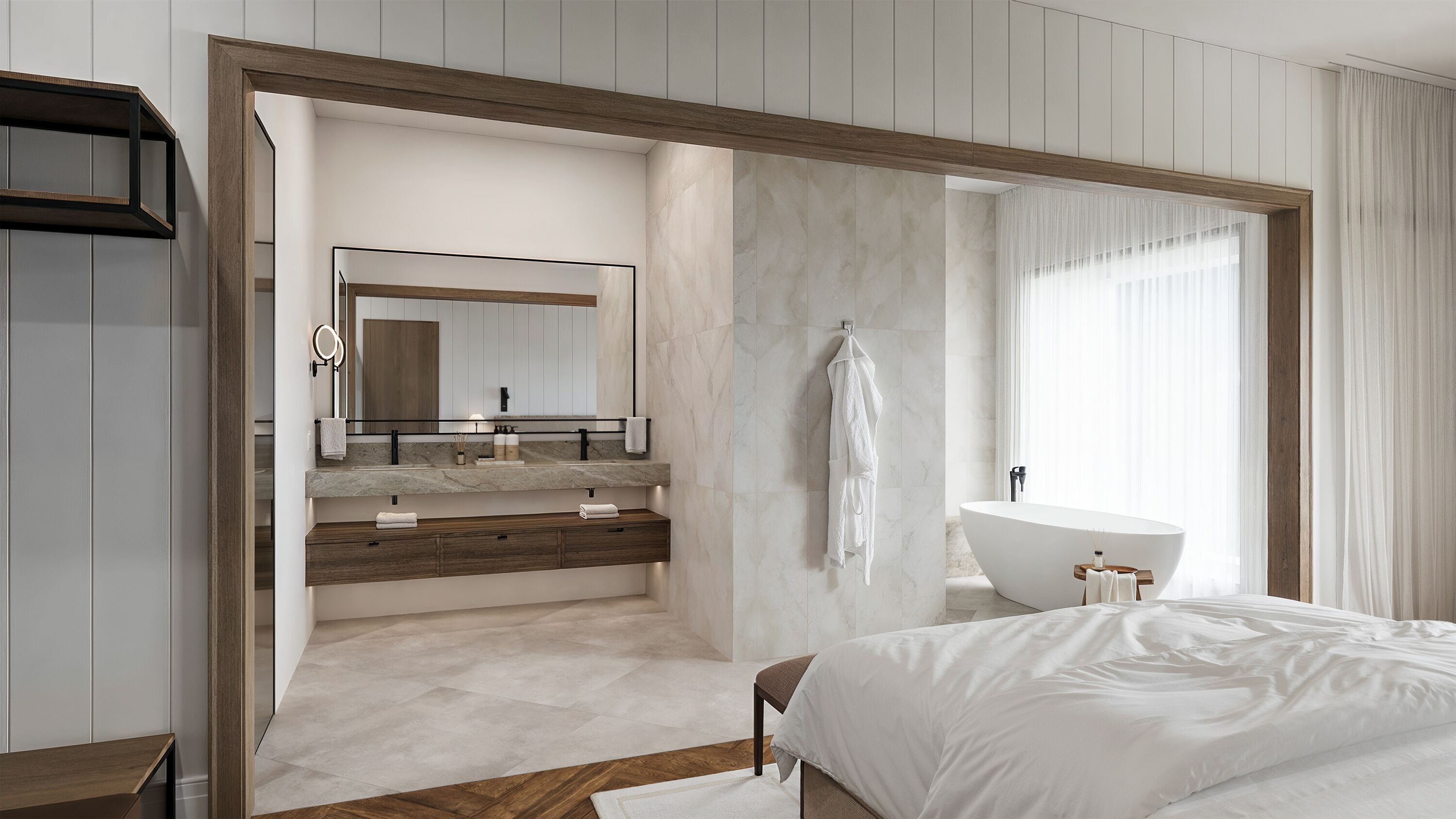 Un dormitorio moderno con una cama grande, un tocador con espejo, una bañera y una puerta con marco de madera.