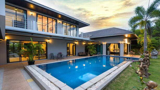 A modern two-story house with a swimming pool, outdoor seating, and a well-maintained garden. - Grand Villa Luxury Holidays Phuket (Choeng Thale)