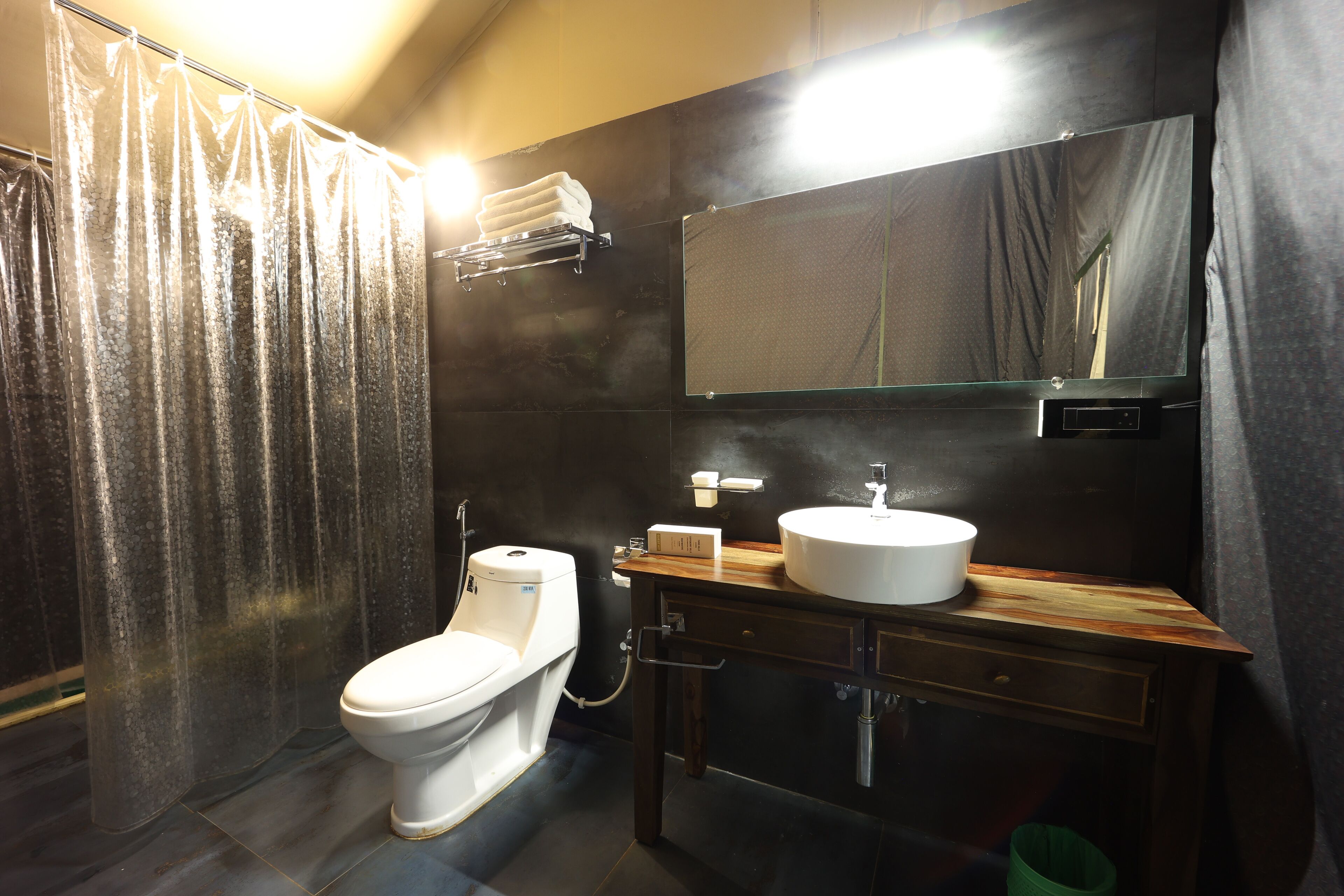 A modern bathroom with a toilet, sink, and mirror.