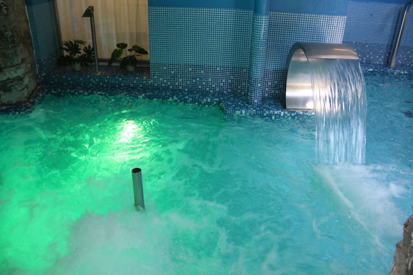 Indoor pool, a waterfall pool, sun loungers