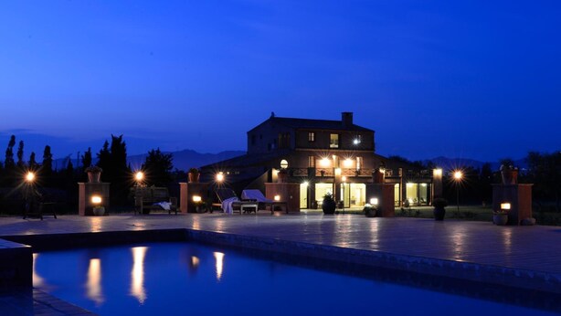 A large building with a pool in front, surrounded by trees and a mountain in the background. - Mas del Mar (Sant Pere Pescador)