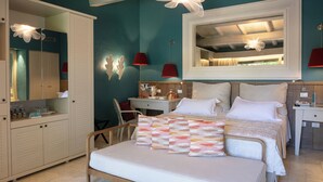 A bedroom with a bed, bedside tables, a desk, and a wardrobe.