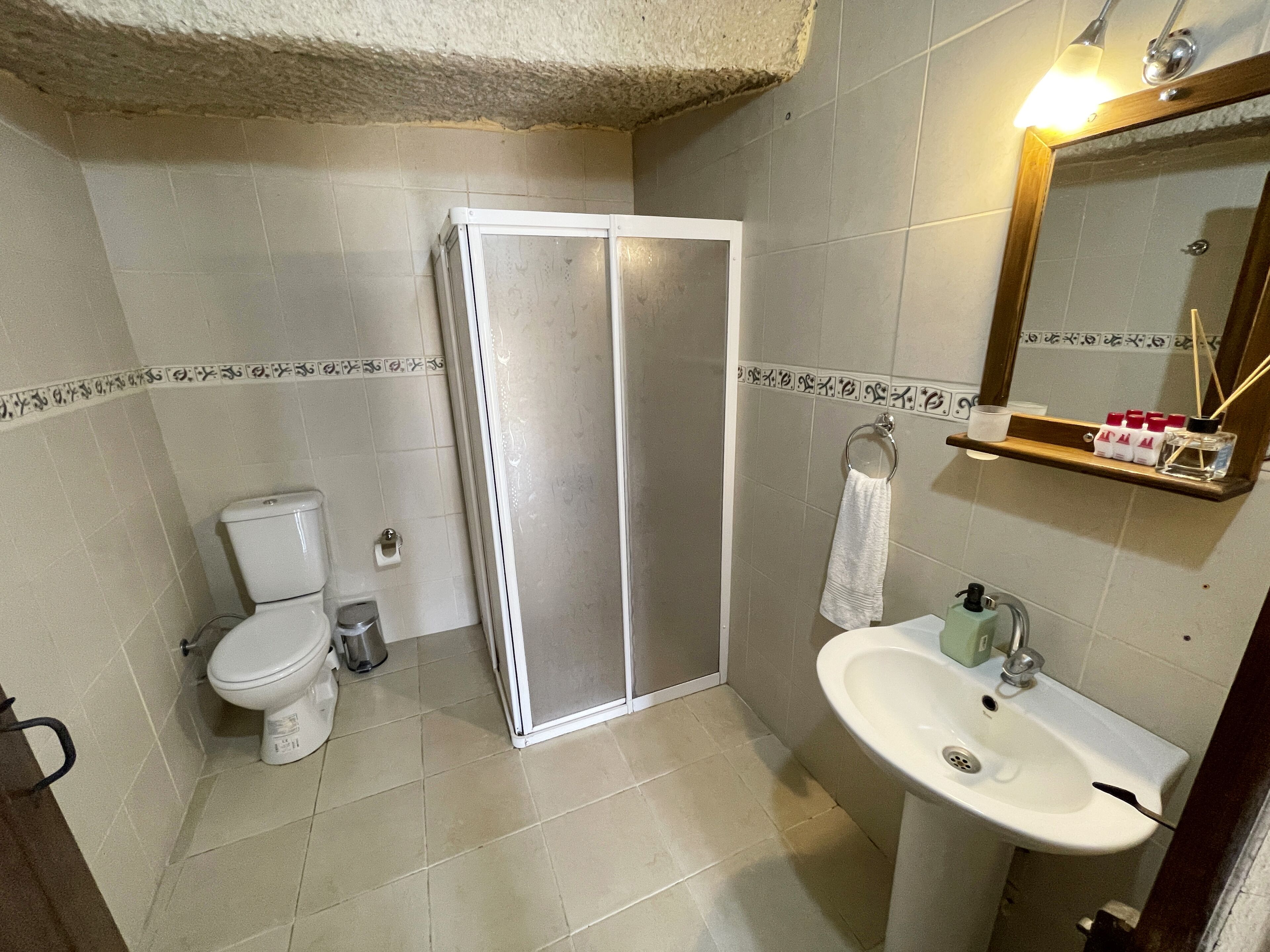 cave double room | bathroom | shower, hair dryer, slippers, towels