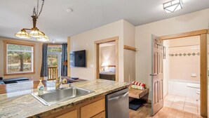A modern kitchen with granite countertops, a dishwasher, and a wooden cabinet. - Ski In-Ski Out Exclusive Lift Access Resort Condo at Mammoth Mountain Lakes CA (Mammoth Lakes)