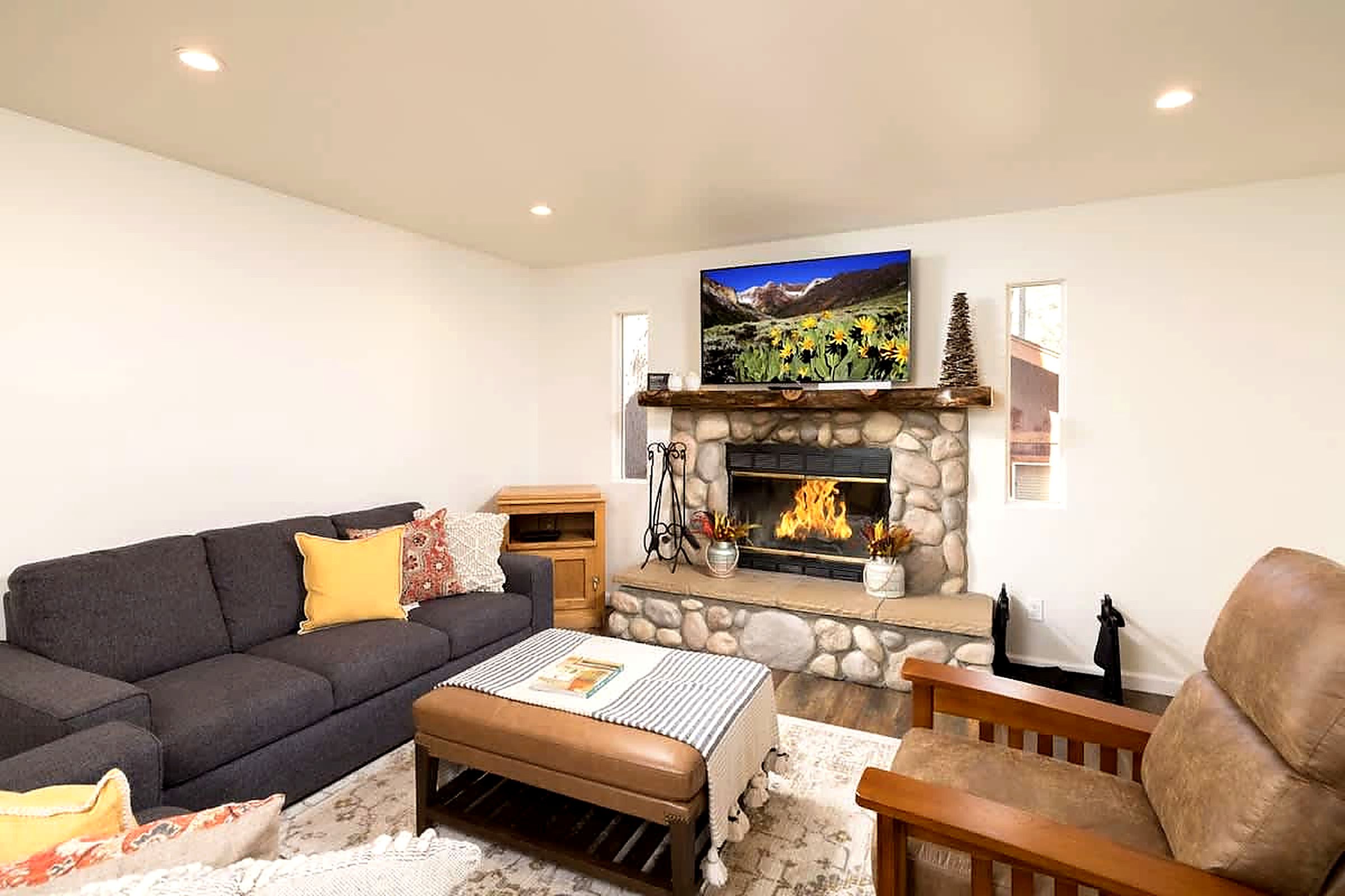 Watch your favorite shows on 55" Roku Smart TV over log fireplace