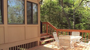 A wooden deck with a table and chairs, a staircase, and a view of trees. - 2 Bedroom + Loft, 2 bath house in The Galena Territory. (Galena)