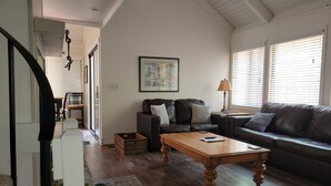 A living room with a sofa, a coffee table, and a painting on the wall. - 2 Bedroom + Loft, 2 bath house in The Galena Territory. (Galena)