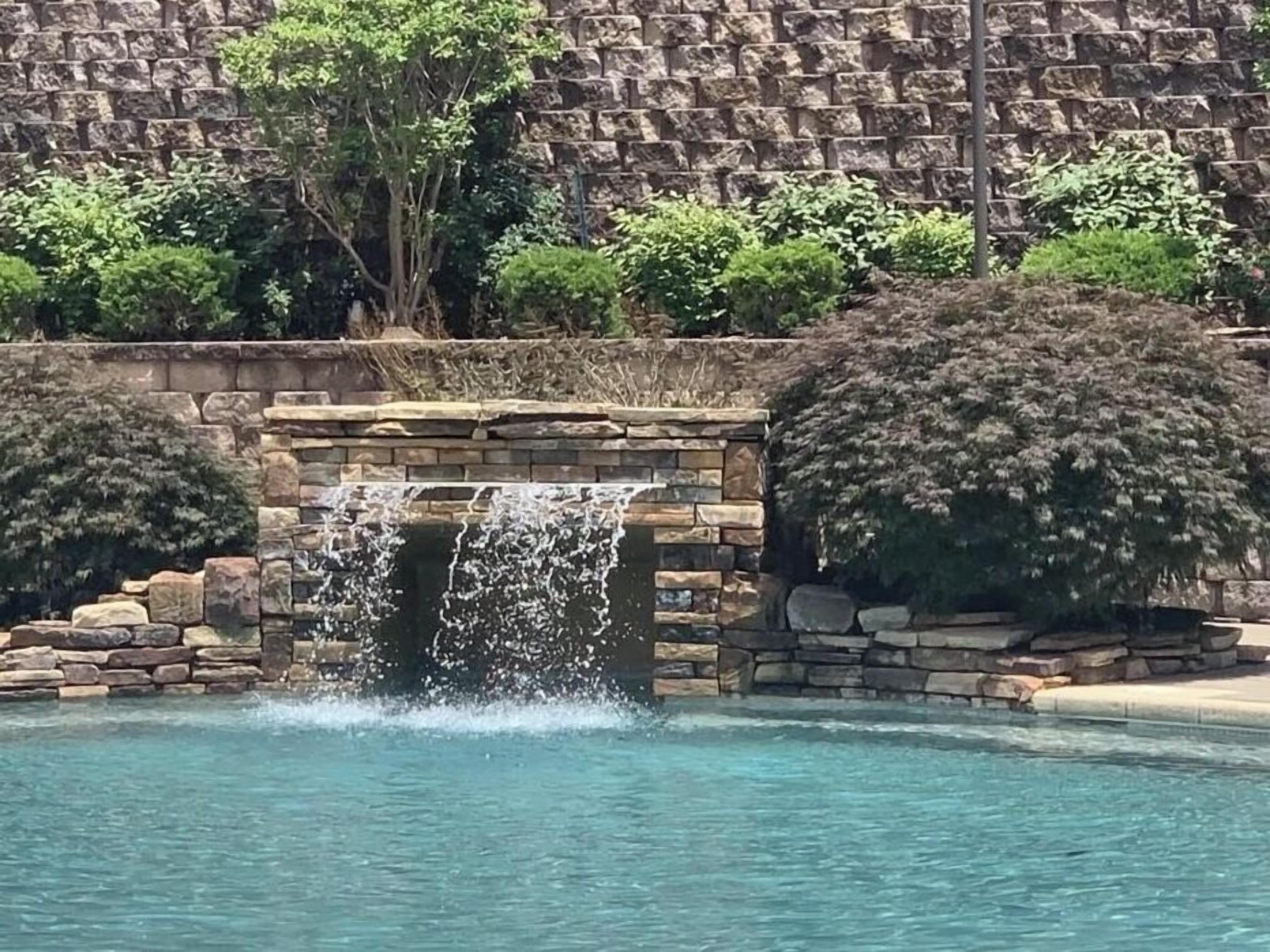 Family pool w/waterfall,is a ledge to sit