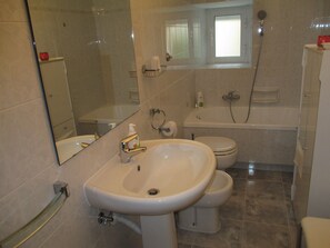 Bathtub, hair dryer, bidet, towels