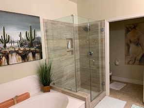 Bathtub, hair dryer, towels, toilet paper